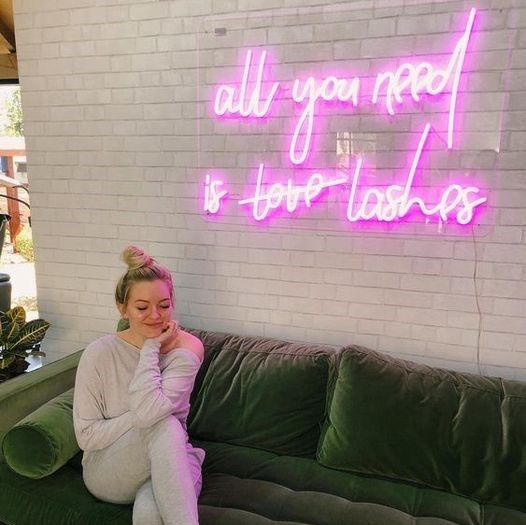 All You Need is Lashes light sign shown in a beauty salon waiting area - from Custom Neon