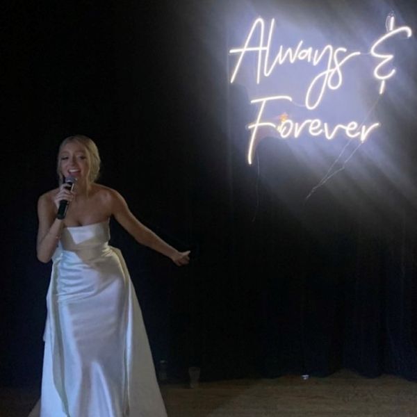 Always & Forever white light sign behind the bride @elle.kayee wedding made by Custom Neon
