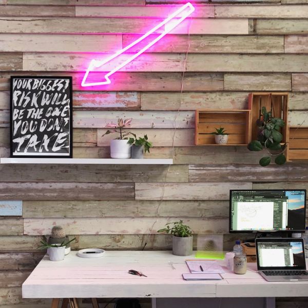 Pink faux neon arrow shown on an office wall - from Custom Neon®