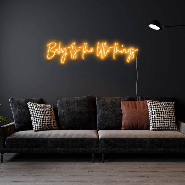 Baby It's The Little Things golden yellow neon flex sign above a couch - design by Custom Neon