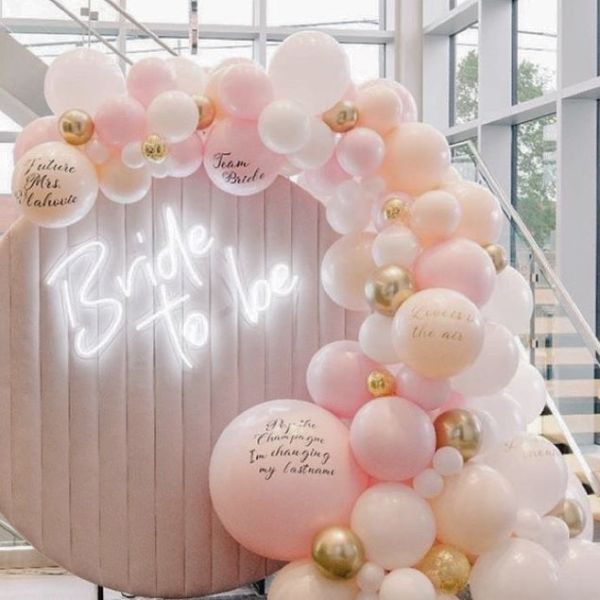 Bride to Be neon sign surrounded by a balloon arch - from Custom Neon