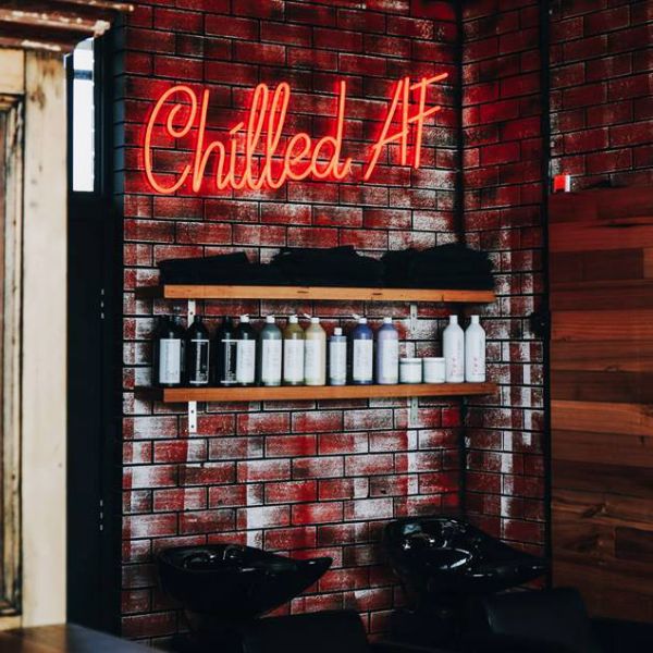 Chilled AF LED neon sign in red above hair basins in a hairdressers - from Custom Neon®