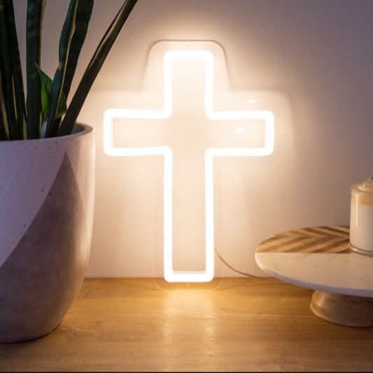 LED neon cross shown illuminated in white, as home decor  - from Custom Neon by Neon Collective