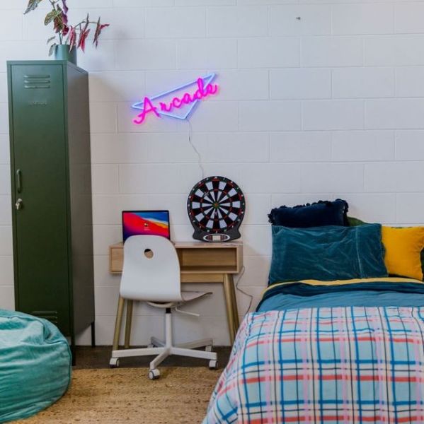 Custom Neon® pink and blue arcade light wall mounted in a teen bedroom.