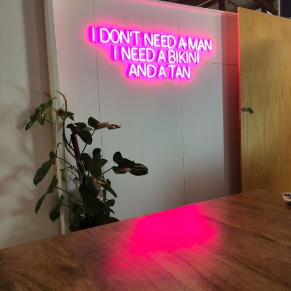 I Don't Need a Man I Need a Bikini and a Tan LED neon flex sign shown illuminated and wall mounted - from Custom Neon®