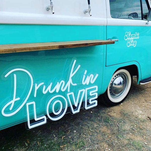 Drunk in LOVE LED Neon Light Sign for Weddings, Bars & Home Decor shown on bar van at an event  - photo CustomNeon.co.uk