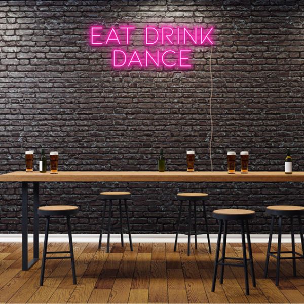 EAT DRINK DANCE pink neon flex sign on brick wall in a pub - from Custom Neon
