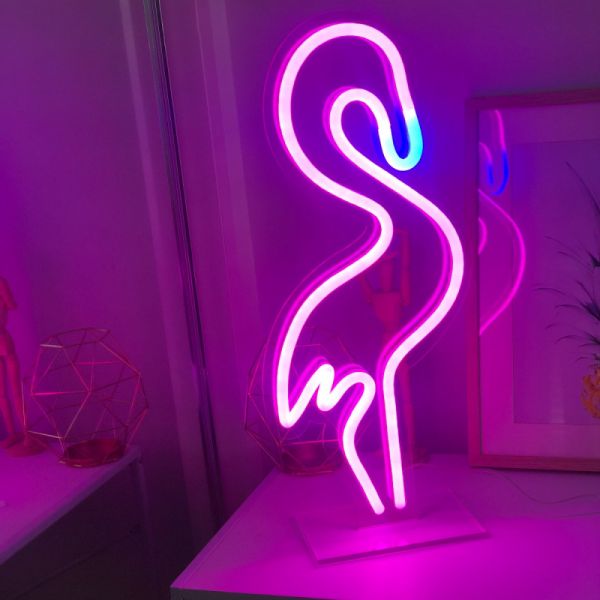 Neon Flamingo Sign in pink, with a blue beak - photo from Custom Neon (formerly Neon Collective)