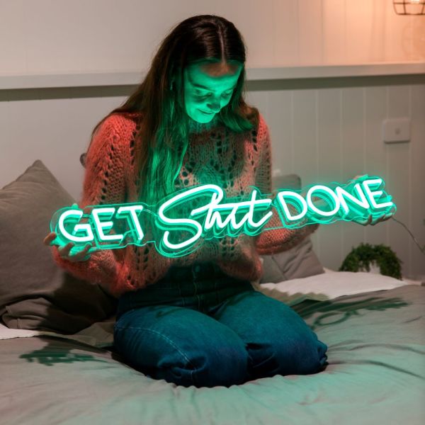 Custom Neon® green Get Shit Done wall sign shown in a bedroom setting