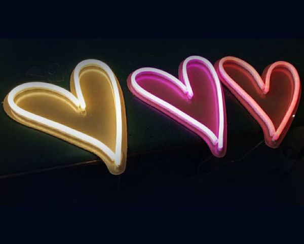 Cute love heart neon lights on coloured acrylic backboard in different colours - photos Custom Neon (formerly Neon Collective)