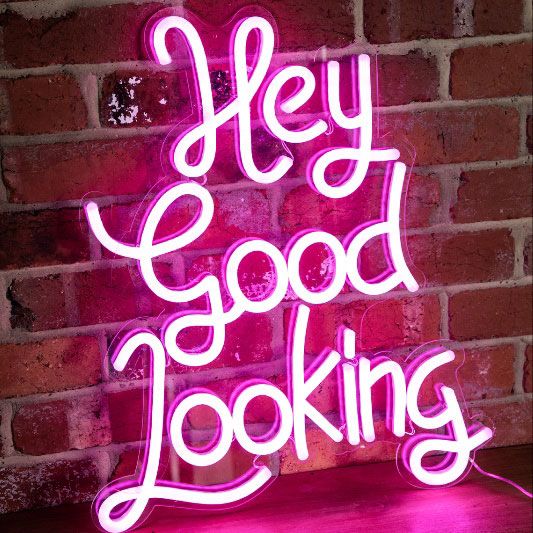 * Hey Good Looking * neon word sign shown on exposed brick wall  - photo from Custom Neon (formerly Neon Collective)
