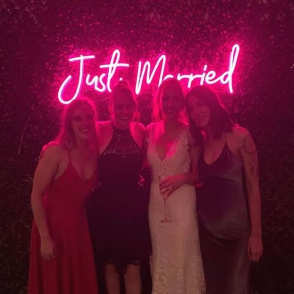 Just Married Light Up Sign hung from a wedding photo backdrop - from Custom Neon™ @customneon