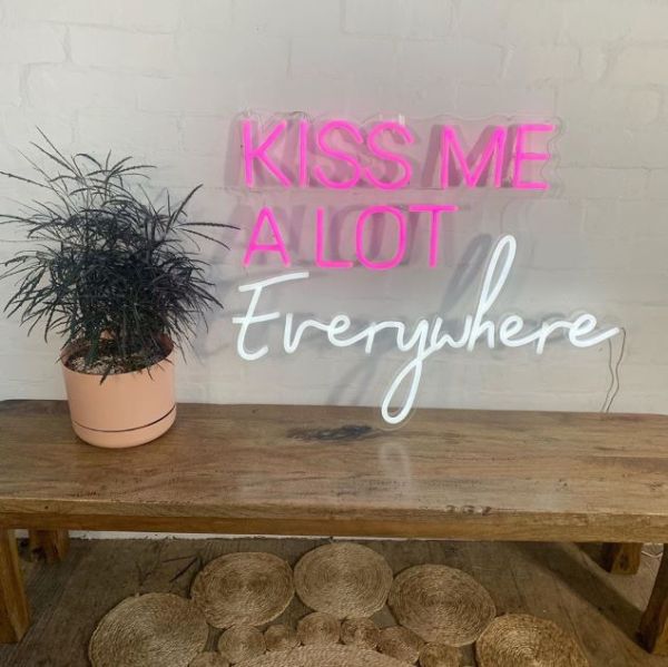 Kiss Me A Lot Everywhere pink & white LED neon sign shown un-illuminated - from Custom Neon