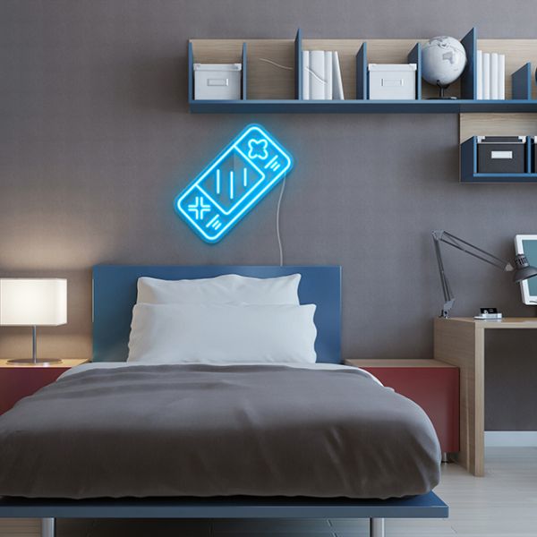 Light Up Games Console Sign by CUSTOM NEON® shown in light blue above a bed in a dorm/teen bedroom
