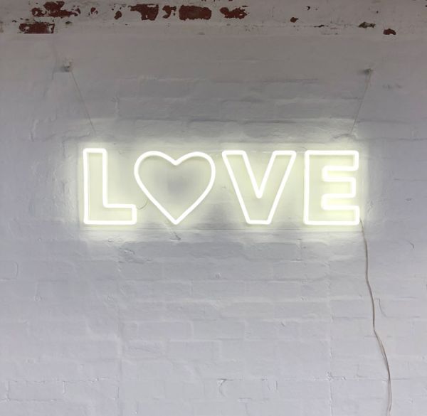 Love LED Neon Letter Light mounted on brick wall
 - photo from CustomNeon.com