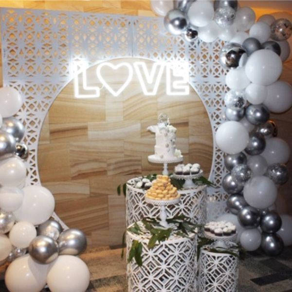 LOVE with a heart LED neon sign surrounded by wedding decorations - photo CustomNeon.co.uk