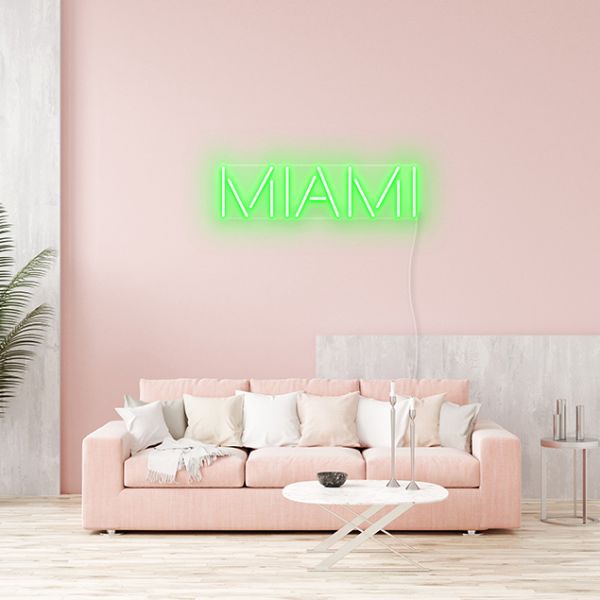 Miami LED Neon Light shown in bright green on a soft pink wall - by CUSTOM NEON®