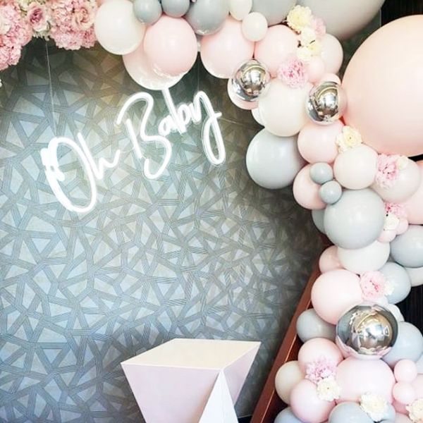 Oh Baby trendy baby shower sign shown surrounded by balloons - photo from CustomNeon.co.uk