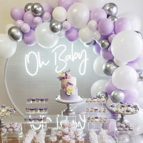Oh Baby baby shower sign shown surrounded by balloons and cakes - photo from CustomNeon.co.uk