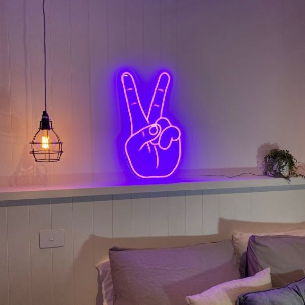 Peace hand LED neon light show in purple above a bed - from Custom Neon