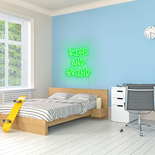 Rise and Grind green CUSTOM NEON® sign shown on blue wall in dorm/teen room