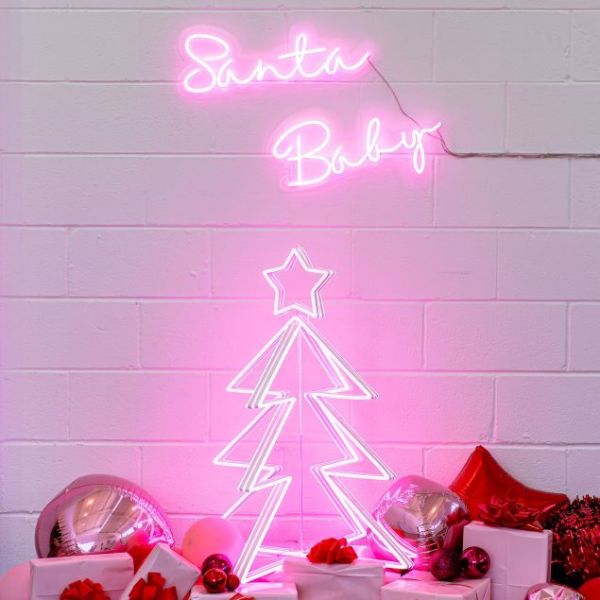 Santa Baby LED neon light sign in pink shown above a pink neon Christmas tree - from Custom Neon
