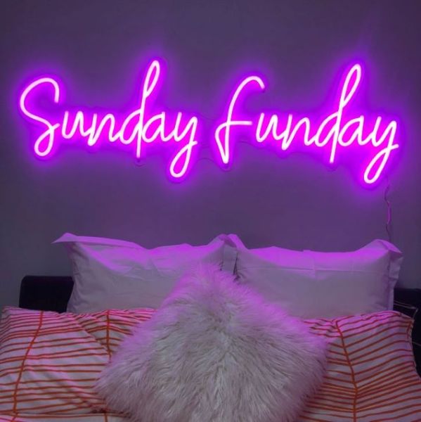 Sunday Funday Neon Wall Sign shown above a bed - from Custom Neon®