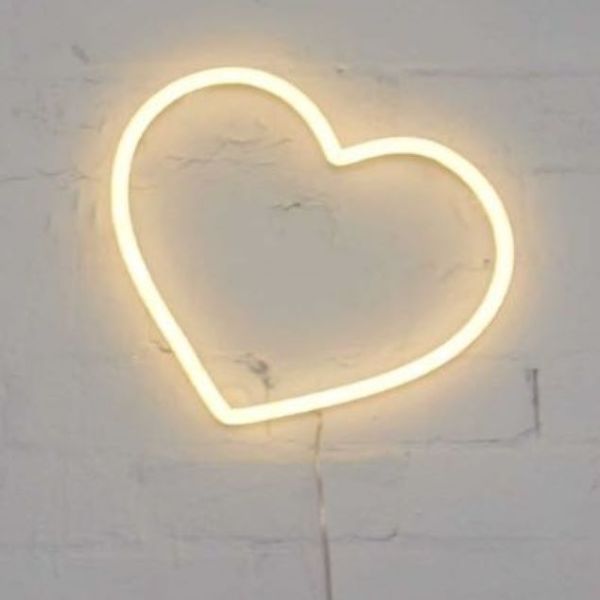 Small Neon Heart Light mounted on a brick wall from Custom Neon®