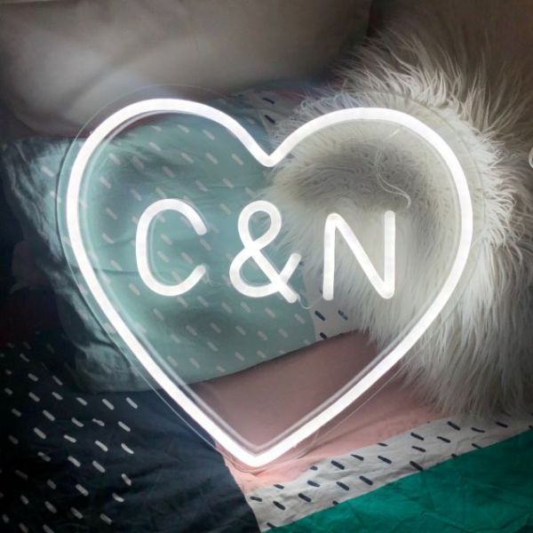 Personalized Heart Neon Sign in LED Flex with clear acrylic background, shown on a pillow - from Custom Neon®