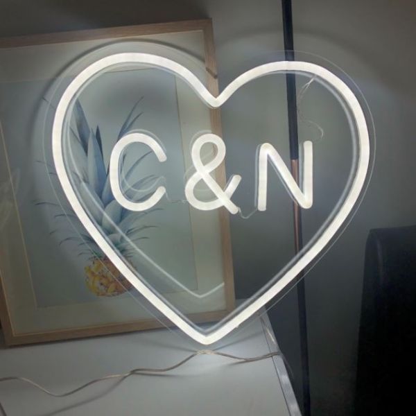Small LED neon heart light that can be personalized with your initials, displayed on a desk - photo from Custom Neon®