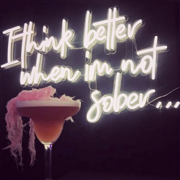 I Think Better When I'm Not Sober LED neon bar sign shown with cocktail - photo from CustomNeon.co.uk