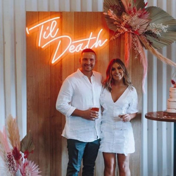Til Death faux neon sign on the photo wall surrounded by wedding decorations - from Custom Neon