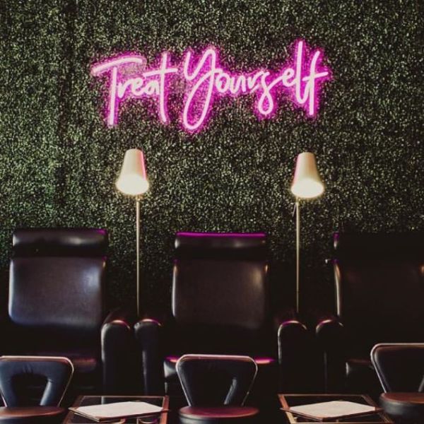 Treat Yourself pink light sign on a green wall in a nail bar - from Custom Neon