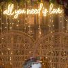 All You Need is Love cursive neon sign shown as wedding decor - from Custom Neon®