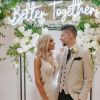 Better Together LED neon wedding sign behind the happy couple - from Custom Neon