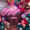 Crazy In Love Wedding Sign in brilliant LED neon flex shown in pink with balloons - photo from CustomNeon.co.uk