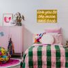 Love You To The Moon and Back Gold Sign by CUSTOM NEON® shown in a girl's bedroom