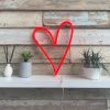 Red love heart neon light on a shelf against distressed wood - from Custom Neon
