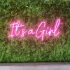 It's a Girl pink neon sign on a green wall - from Custom Neon