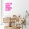 Live is now press play pink LED neon shown as wall art - design by Custom Neon