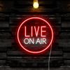 Live on Air studio sign by CUSTOM NEON® in white and red against a black stone wall