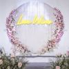 Love Wins LED neon sign in yellow amidst a floral display - from Custom Neon
