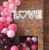 Beautiful, modern neon letter lights spelling the word LOVE with a heart for the O
 - photo from Custom Neon by Neon Collective
