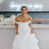 Loving you is yeezy wedding neon sign shown in white behind the bar with a beautiful bride in front - photo from CustomNeon.co.uk @customneon
