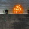 No Fake Shit neon look sign shown against a brick wall - by Custom Neon