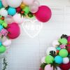LED neon heart personalised with the bride & groom's initials. Shown here on a mesh background surrounded by balloons. Photo from CustomNeon.co.uk