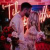 Til Death LED neon sign shown behind the happy couple at a wedding - photo from CustomNeon.co.uk @customneon