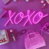 XOXO pink Custom Neon® sign shown against a pink background