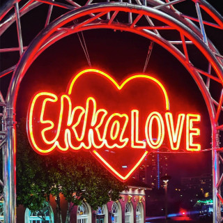 Custom Neon® red sign on metal archway at entrance to @ekkalove festival