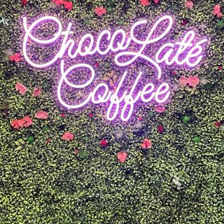 Pink Custom Neon® sign on green wall @chocolattecoffee